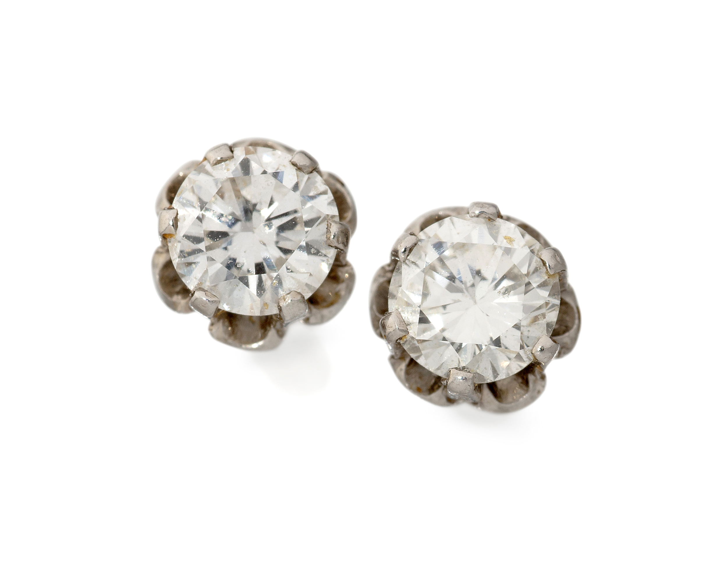 A pair of 18ct white gold single stone diamond stud earrings, a brilliant-cut diamond, claw set t...