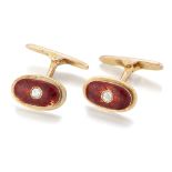 A pair of diamond and enamel cufflinks, the oval panels with a brilliant-cut diamond set to the c...