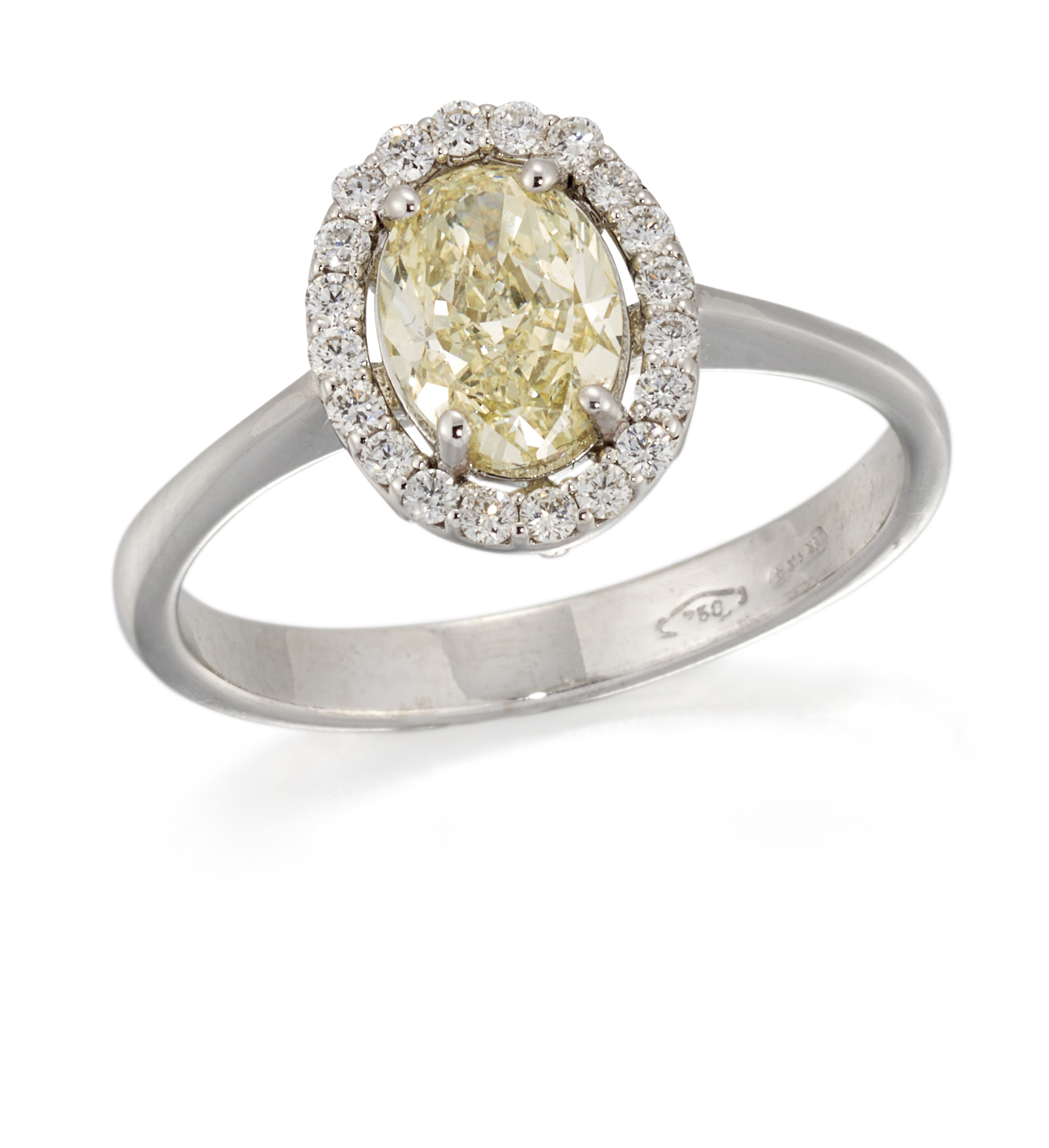 A light yellow diamond cluster ring, an oval brilliant-cut light yellow diamond, claw set to halo...