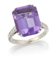 A diamond and amethyst ring, the emerald cut amethyst in double four claw setting to pavé-set dia...