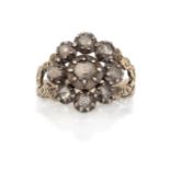 A 19th century diamond cluster ring, rose-cut diamonds in silver clawed-collets, to gold bifurcat...