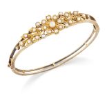 An Edwardian gold seed pearl and half-pearl hinged bangle,