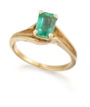 A single stone emerald ring, the emerald-cut emerald, claw set, to crossover style shoulders and ...