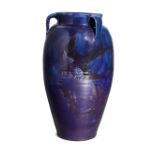 William Baron, Barnstaple  Blue three handled vase with painted decoration of a bird amongst blo...