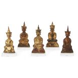 Five Burmese parcel-gilt Buddhas, 18th century, each Buddha with a crown seated on a base with ha...