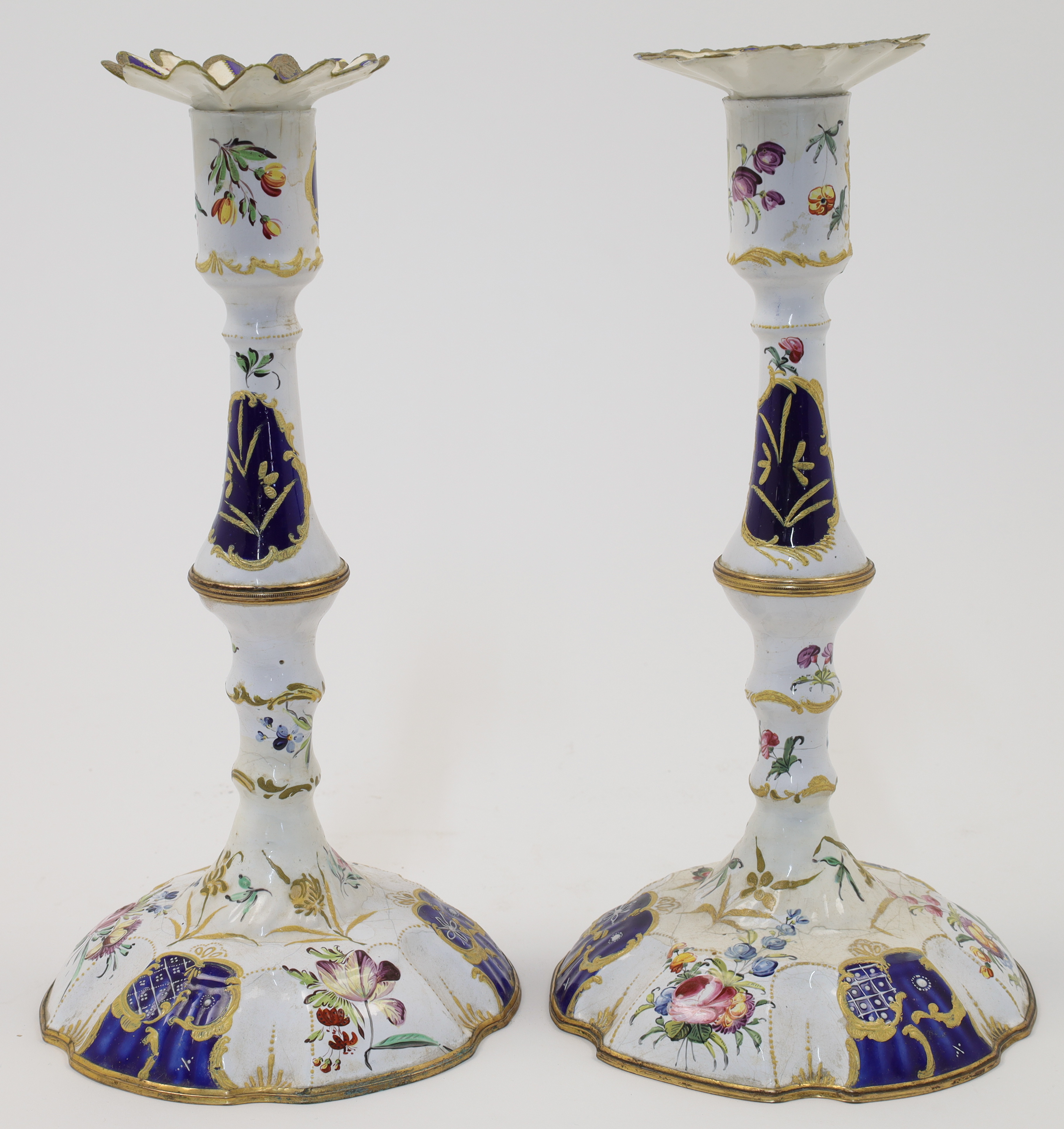 WITHDRAWN A pair of Staffordshire enamelled candlesticks, 19th century, the stem of baluster form