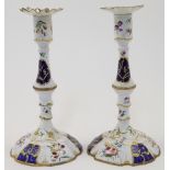 WITHDRAWN A pair of Staffordshire enamelled candlesticks, 19th century, the stem of baluster form