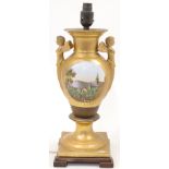 A gilded porcelain and gilt metal French Empire style table lamp, 20th century, modelled as a bal...