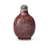 A Chinese red-glazed snuff bottle, Republic period, apocryphal four-character Qianlong mark, the ...