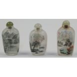 Three Chinese inside painted glass snuff bottles, 19th century, each decorated with mountainous l...