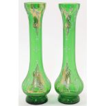 A pair of Bohemian green glass vases, 20th century, of elongated baluster form with ogee rim and ...