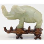 A Chinese hardstone elephant, 20th century, naturalistically carved with the trunk raised, the st...