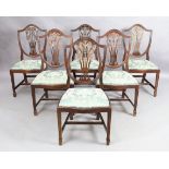 A set of six English mahogany dining chairs, Hepplewhite style, 20th century, the shield backs ca...