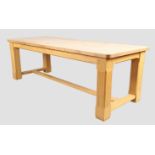 A large solid light oak refectory table, late 20th century, the plank top with rounded corners, a...