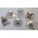A group of six silver and silver mounted inkwells, comprising: a capstan inkwell, Chester, 1915, ...