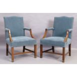 A pair of English mahogany Gainsborough armchairs, in the George III style, 20th century, on squa...