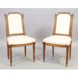 A pair of French walnut side chairs, Louis XVI style, 19th century, silk upholstery, on fluted le...