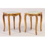 A pair of French beechwood occasional tables, 20th century, with marble tops and floral carved fr...