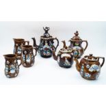 A collection of Victorian Bargeware teapots and jugs, comprising: a large teapot and cover with t...
