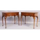 A pair of English walnut side tables, Queen Anne style, 20th century, the galleried tops above si...