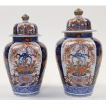 A pair of Japanese jars and covers, 20th century, decorated in the Imari palette of red, blue and...