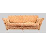 A modern three seat sofa, possibly by Duresta, with red and beige damask upholstery, raised on ma...