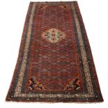 A Persian Feraghan wool rug, first quarter 20th century, central red ground field, with multiple ...