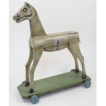 A naïve carved and painted wood toy horse, possibly French, 19th / 20th century, standing four sq...
