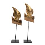 A pair of Thai giltwood finials, 18th/19th century, carved as foliate scrolls, 26cm high, metal d...