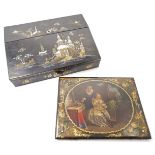 A papier-maché blotter, 19th century, decorated to the centre with an interior scene of two ladie...