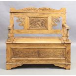 A carved oak box seat settle, second quarter 20th century, 97cm high, 106cm wide, 40cm deep