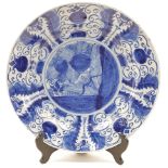 A Dutch Delftware blue and white charger, 18th / 19th century, tin glazed and painted to the cent...