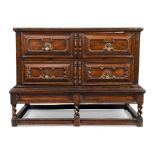 An English oak chest on stand, 18th century, the two long drawers with cushioned geometric carvin...