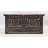 An English oak coffer, 18th century, floral carved, the hinged lid enclosing candle box and compa...