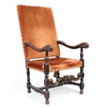 An English oak armchair, in the William and Mary style, 19th century, the high velour upholstered...