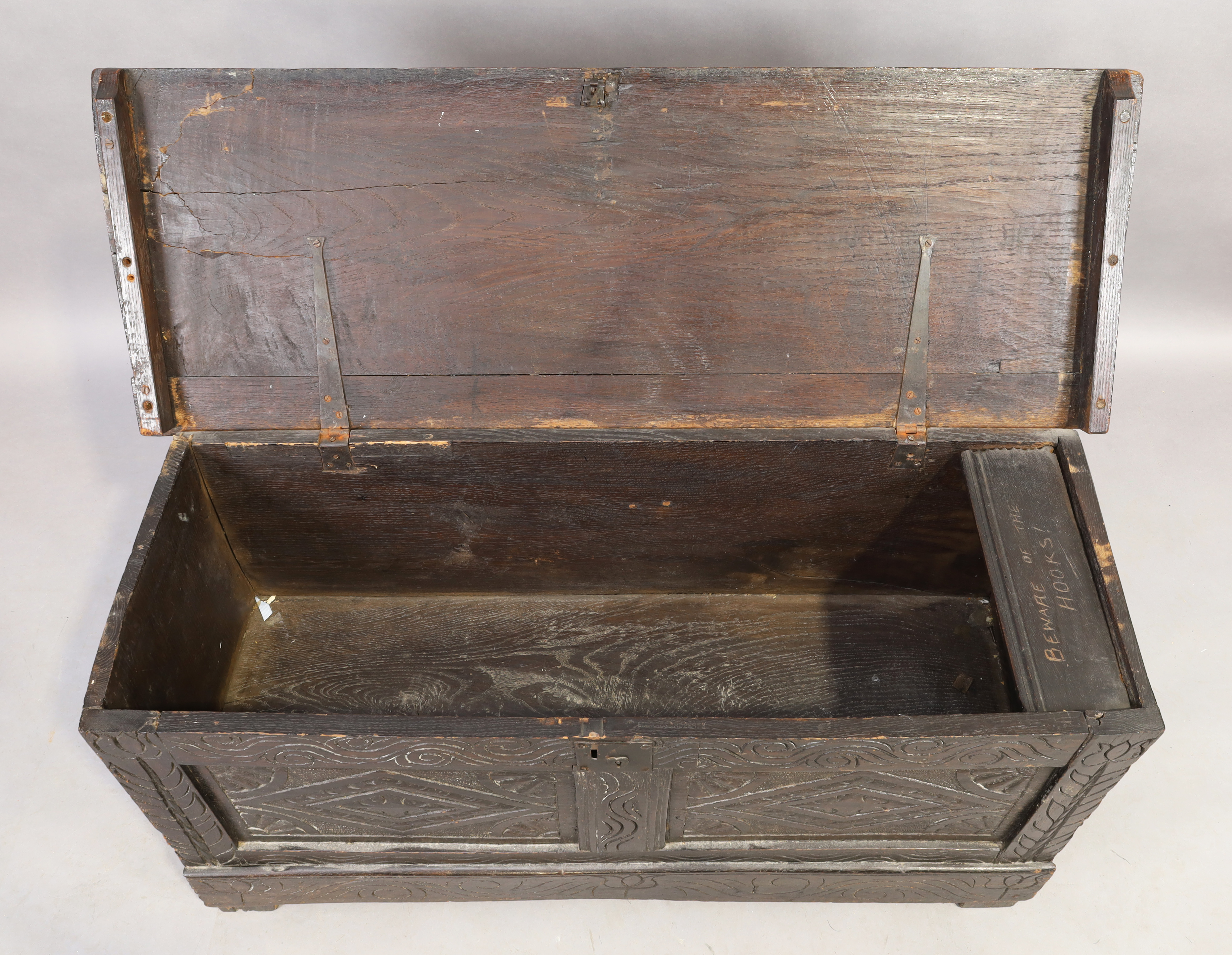 An English oak coffer, 18th century, floral carved, the hinged lid enclosing candle box and compa... - Image 3 of 4