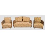 An Art Deco three piece walnut  bergere suite, first quarter 20th century, with caned backs and d...