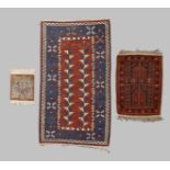 Three various rugs, 20th century, to include a Turkish Konya rug, blue, terracotta and cream grou...