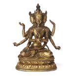 A Sino-Tibetan gilt-bronze figure of a multi-armed deity, late Qing dynasty, with three faces and...