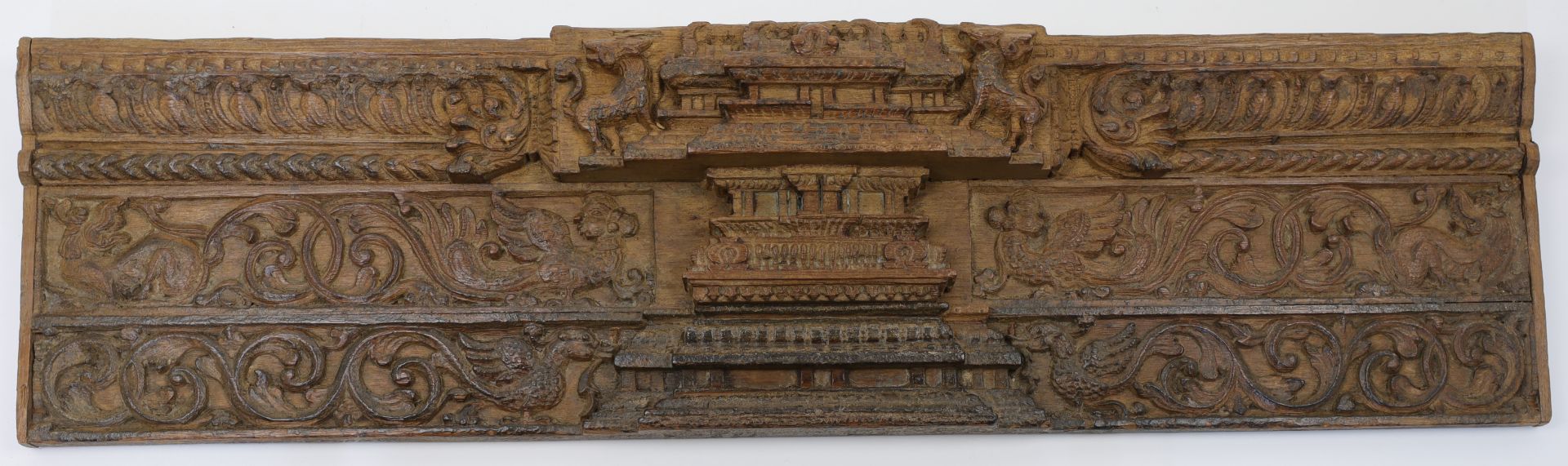 A carved relief wood panel in the South East Asian style, 20th century, with architectural featur...