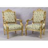 A pair of French giltwood armchairs, Louis XV style, 20th century, with cream ground upholstery w...