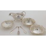 A small group of silver, comprising: a Victorian sauce boat, Birmingham, 1898, Thomas Hayes, with...