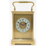 A gilt brass carriage clock, late 19th century, the corniche case with swing handle, bevelled gla...