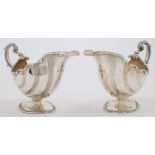 An pair of silver sauceboats, London, 1901, Charles Stuart Harris, each with scalloped rim and sc...