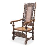 An English caned walnut armchair, in the Charles II style, 19th century, after Richard Price, the...