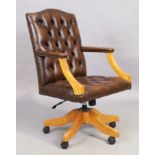 A brown leather desk chair, in the George III style, 21st century, with button back upholstery, o...