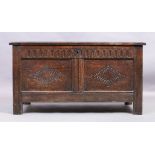 An English oak coffer, 18th century, the hinged top enclosing candle box and compartment, carved ...