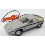 An electronic remote controlled Porsche 928 toy car manufactured by Rico, Spain, c.1970, with att...