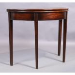 A George III mahogany demi lune tea table, last quarter 18th century, the fold over top raised on...