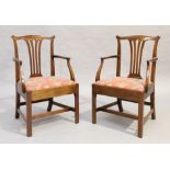 A pair of George III mahogany armchairs, last quarter 18th century, on chamfered legs joined by s...